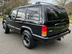 a black suv parked in a parking lot