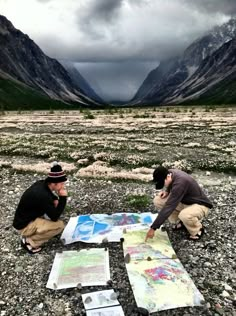 two men looking at a map on the ground