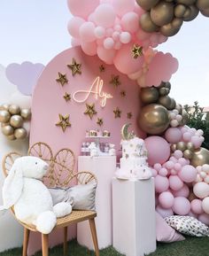 a pink and gold birthday party with balloons, stars, clouds and other decorations on the wall