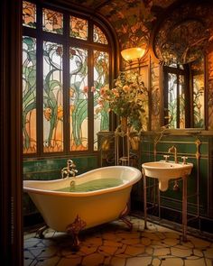 an ornate bathroom with stained glass windows and a claw foot tub in the center, along with two sinks