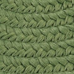 close up view of the braiding on a green fabric textured with grass fibers