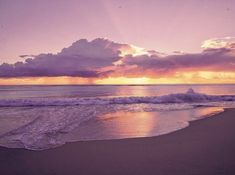 the sun is setting over the ocean with clouds in the sky and waves on the beach