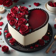 a heart shaped cake decorated with red roses