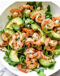 shrimp and avocado salad in a white bowl on a marble countertop, ready to be eaten