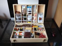 an open wooden box filled with assorted items