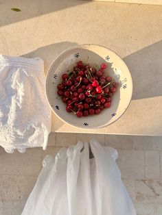 a bowl of cherries on a table next to a diaper