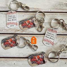 four baseball key chains with different pictures on them