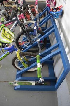 several bikes are parked on the side of a building