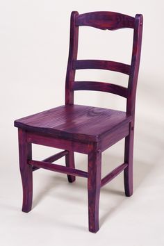 a wooden chair sitting on top of a white floor