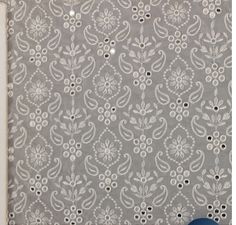 a gray and white wallpaper with an intricate design on the top, in front of a window