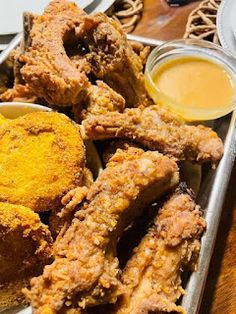 fried food on a tray with dipping sauces