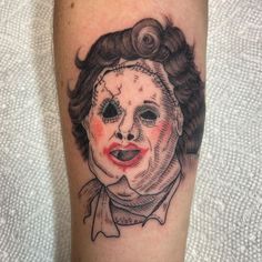 a tattoo with a creepy clown face on it