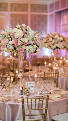 the tables are set with pink and white flowers