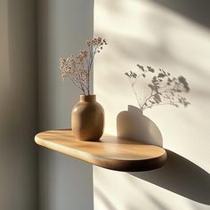 two vases are sitting on a wooden shelf