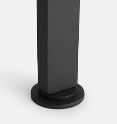 a black pedestal with a phone on it