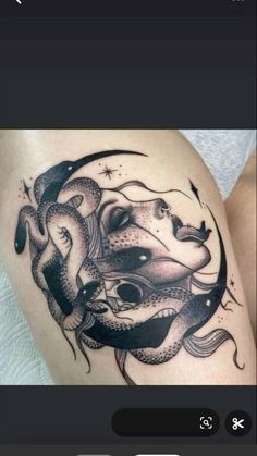 a woman's thigh with an octopus and snake tattoo on the side of her leg