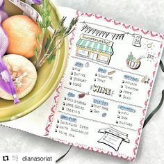 a bowl filled with fruit and vegetables next to a recipe book on top of a table