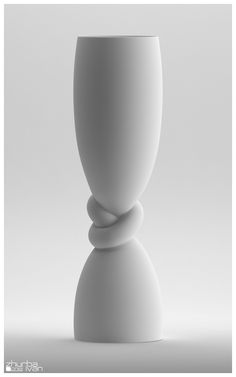 a white vase sitting on top of a table