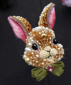 a close up of a beaded rabbit head