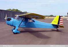 a blue and yellow airplane sitting on top of an airport tarmac