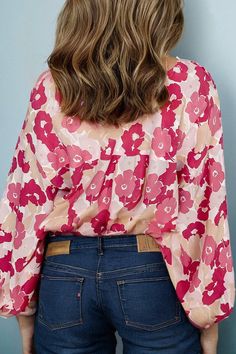 Add some flower power to your wardrobe with the Blooming Bridget Blouse Top. This quirky top boasts a playful and fun vibe with its unique design and versatile fit (available in sizes S-XL). Get ready to turn heads and make a statement with this must-have blouse top! -fits true to size Spring Graphic Print Stretch Blouse, Spring Stretch Blouse With Graphic Print, Trendy Pink Printed Tops, Spring Floral Print Stretch Tops, Trendy Floral Print V-neck Blouse, Playful Long Sleeve Tops For Day Out, Trendy Pink Blouse With Graphic Print, Trendy Stretch Printed Blouse, Trendy V-neck Blouse With Floral Print