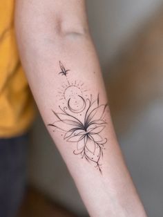 a woman's arm with a tattoo on it and a flower in the middle