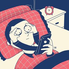 a man laying in bed while looking at his cell phone with an alarm clock on the wall behind him