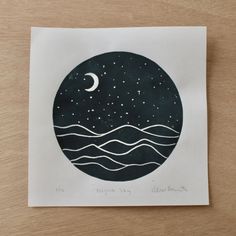 a paper cut with the moon and stars above water