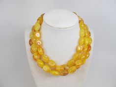 "Chunky gold yellow marigold necklace, multi strand statement yellow necklace, beaded yellow necklace, big gold beads, marigold statement jewelry, matching earrings, A bold and dramatic statement necklace featuring acrylic yellow nugget beads. 3strands, light weight. Gold plated lobster clasp. Measurements: 16\" (43 cm) plus 3 1/2\" extender. Each piece of jewelry from my shop comes beautifully packaged in box and ready for gift giving. Thank you for shopping at my shop! D 7" Luxury Yellow Necklaces With Round Beads, Luxury Yellow Round Beaded Jewelry, Yellow Multi-strand Polished Beads Jewelry, Yellow Multi-strand Jewelry With Polished Beads, Yellow Jewelry With Polished Oval Beads, Yellow Oval Polished Bead Jewelry, Yellow Multi-strand Polished Beaded Necklaces, Yellow Multi-strand Jewelry As A Gift, Yellow Multi-strand Jewelry Gift