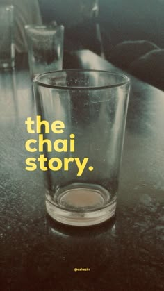 a shot glass with the words the chai story written on it sitting on a table