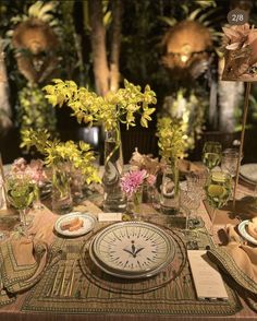 the table is set with flowers and plates