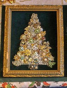 a christmas tree made out of buttons in a gold frame