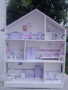 a doll house with furniture and accessories on the front porch, in white painted wood