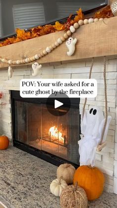 a fireplace decorated for halloween with pumpkins and ghost decorations