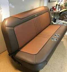 a tan and black leather seat in a room