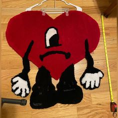 a heart shaped rug with an angry face on it