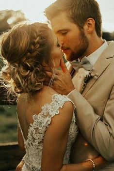 a man and woman kissing each other on their wedding day