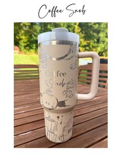 a coffee cup sitting on top of a wooden table with the words coffee club printed on it