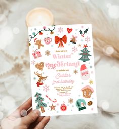 a person holding up a card with christmas decorations on it and the words winter engeinhand