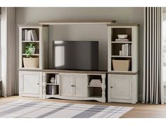 an entertainment center with bookshelves, cabinets and a television