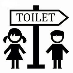 a black and white sign with the words toilet next to two people standing under it