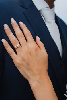 a man and woman wearing wedding rings on their fingers