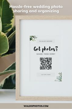 a white framed photo with the text get photos? share them here on it and next to a potted plant