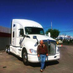 a man standing in front of a semi truck