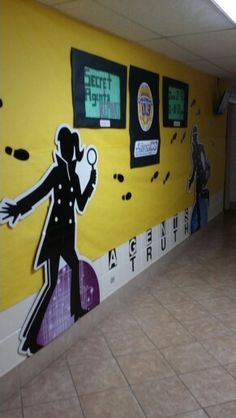 this is a hallway with a mural on the wall that depicts a man holding a tennis racquet