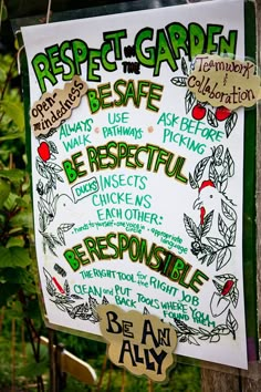 a sign posted on a wooden post in front of some trees and bushes with words written below it