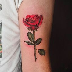 a red rose tattoo on the left arm