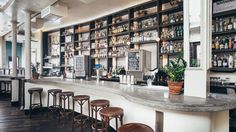 an empty bar with stools in front of it