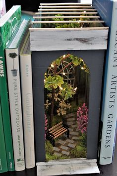 an image of a small garden in the middle of some books