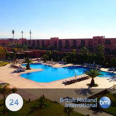 an aerial view of the swimming pool at the british mid - atlantic international hotel in oman